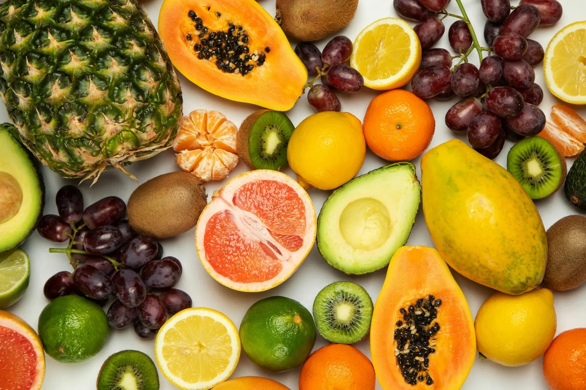 Assortment of tropical and exotic fruit: papaya, mango, avocado, citrus, kiwi